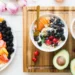 A bowl of fruit and a cup of coffee on a wooden cutting board, creating the perfect morning boost with a burst of natural energy.