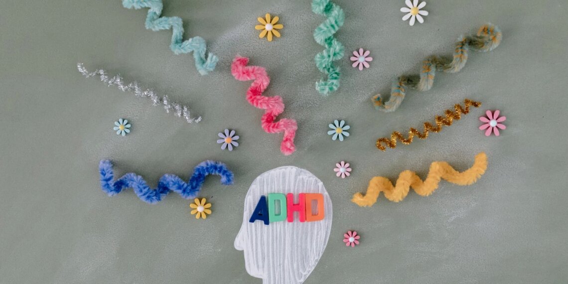 A head with a bunch of colorful strands surrounding it, representing the vibrant nature of ADHD.