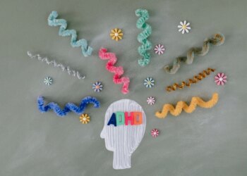 A head with a bunch of colorful strands surrounding it, representing the vibrant nature of ADHD.