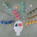 A head with a bunch of colorful strands surrounding it, representing the vibrant nature of ADHD.