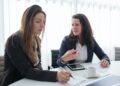 Two business women having an effective meeting in a conference room.