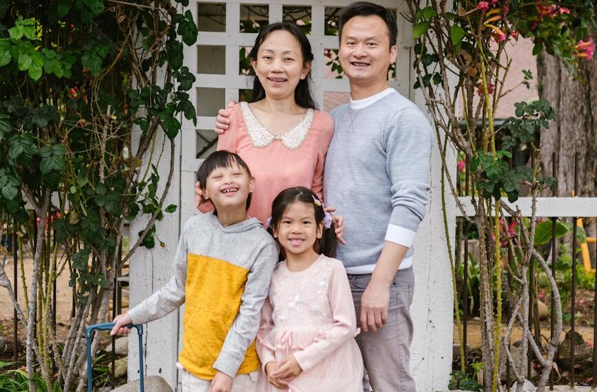 parents with a down syndrome son and cute daughter standing on a park